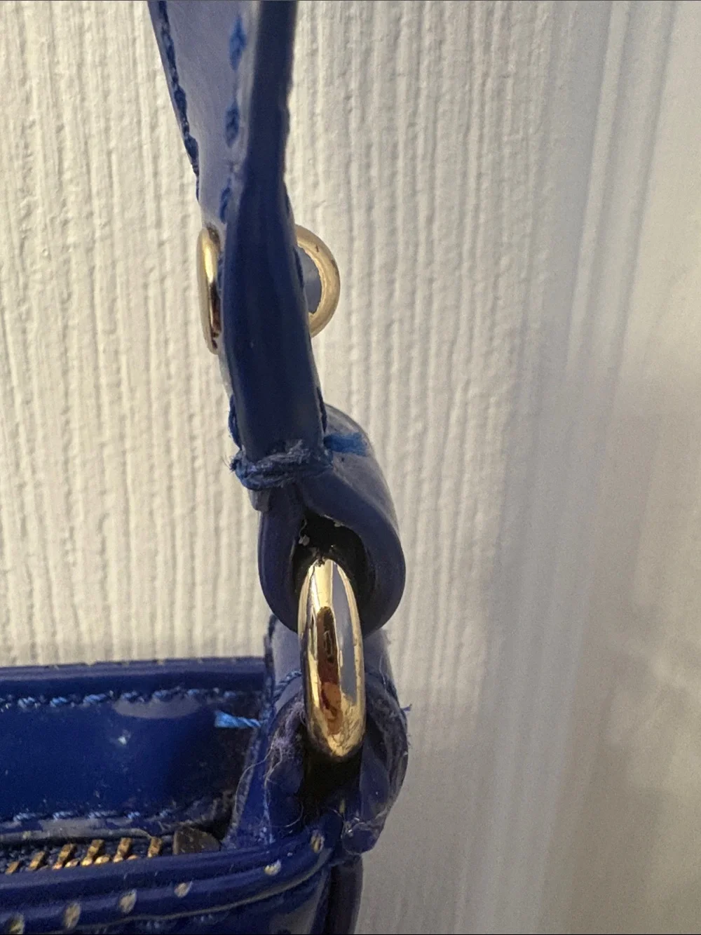 Kate Spade heart perforated patent leather crossbody in cobalt blue.